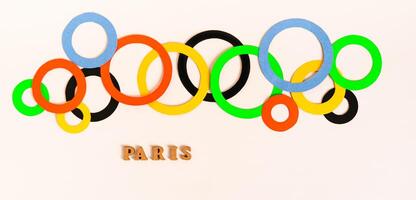 Olympics, Paris, France, summer, 2024. Multi-colored rings and text on a light web banner photo