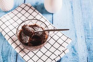 Homemade sweet cake in a mug made in the microwave on the table photo