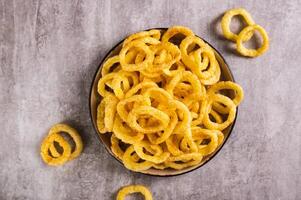 Close up of onion rings  on a plate on the table top view photo