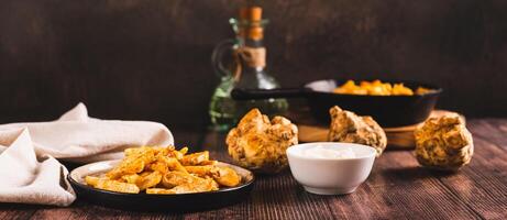 Pieces of celery root fried with paprika on a plate on the table web banner photo