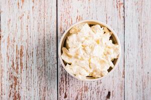 Close up of traditional mascarpone cheese in a bowl on the table top view photo