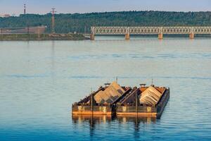 dry cargo barges with sand stand on the roadstead against the background of bridges across the river photo