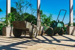 soiled wheelbarrows and shovels at landscaping photo