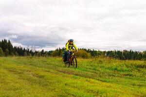 cyclist traveler rides through the natural landscape photo