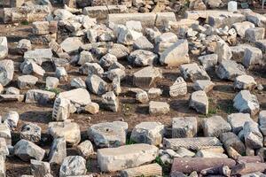 stones, debris and fragments of ancient buildings at the archaeological site of the antique city of Side photo
