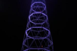 fragment of lattice TV tower against the background of night darkness photo