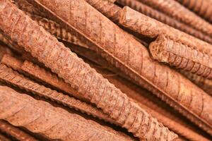 rusty reinforcing bars piled in a heap close-up photo