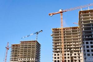 multistory buildings under construction, view against the sky photo