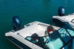 two moored motorboats with outboard motors photo