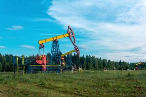 oil pumpjacks in a clearing in the forest photo