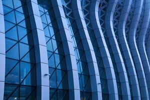 section of the intricately curved facade of a modern building photo