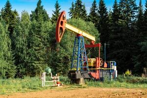 oil pumping stations in a clearing in the forest photo