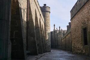 passage between the walls of an old palace that looks like a medieval street photo