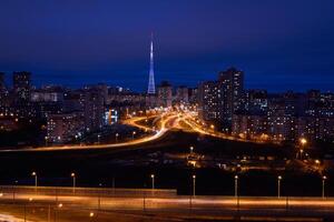 night view of Perm city, Russia, with illuminated TV tower in the distance photo