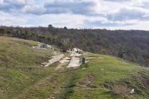 ancient road with carriage ruts worn in stone for a long time photo