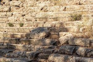 dilapidated steps-benches in the stands of an antique stadium or theater photo