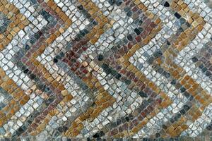 fragment of antique mosaic floor with a pattern of tiles photo