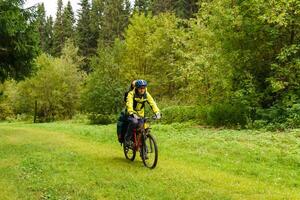 bicycle tourist in the autumn forest photo