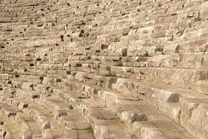 old stone stands of ruined ancient stadium photo