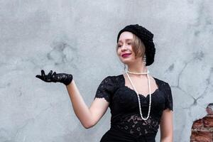 young woman in retro style on a brick wall background photo