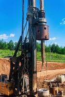 machine for drilling deep piles is preparing to work on the construction of the bridge photo