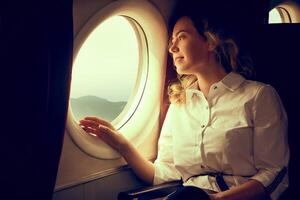 woman is flying as a passenger in airplane, photo in golden tones