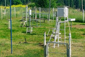 measurement site at a weather station with various meteorological instruments photo