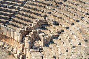 view of the arena and stands of the antique amphitheater in the ruins of Myra Demre, Turkey photo