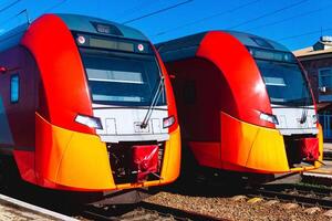 two suburban trains stand at the station photo