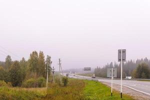 highway in autumn foggy terrain photo