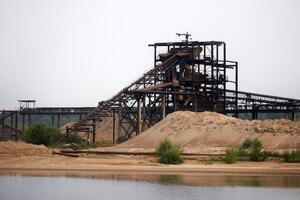 huge stationary separator of sand and gravel on the shore of the reservoir photo