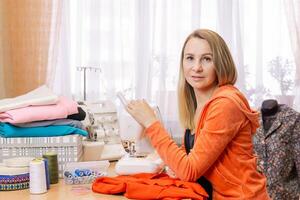 seamstress woman with her equipment at home photo