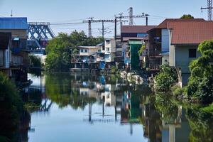 the bank of the Dagomys river is built up with small cottages with garages for boats in Sochy, Russia photo