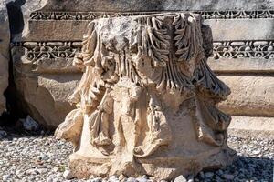 capitals of antique column stacked at archaeological site in Myra, Turkey photo
