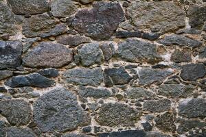 background, texture - ancient masonry at the wall of the castle photo