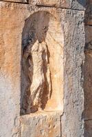 destroyed antique relief, an architectural detail from the ruins of the ancient city of Myra, now Demre, Turkey photo