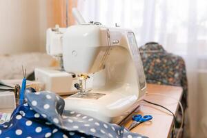 fabric and ready-to-use sewing machine on a table in a room photo
