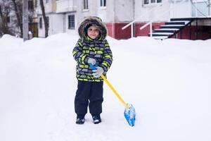 child on a walk in winter in cold snowy weather in an urban environment photo
