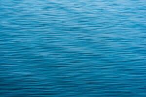 blurred blue water background with waves photo