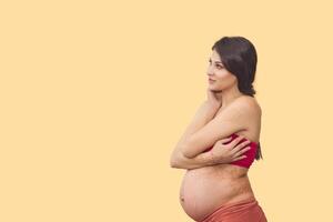 pregnant woman isolated on light background photo