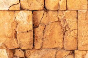 ancient wall texture of cracked stone blocks photo