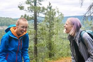 teenagers laugh outdoors on a natural forest background photo