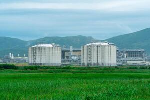 plant for the production of liquefied natural gas in a natural area against the backdrop of mountains photo