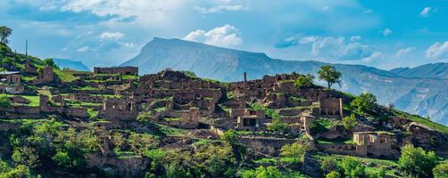 ruins of houses on a mountainside in Kurib, a depopulated village with the only remaining household with an apiary, Dagestan photo