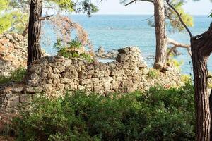 ruins of ancient buildings on the seashore on the site of the former harbor of Phaselis, Turkey photo