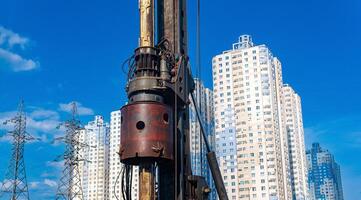 machine for drilling deep piles against the backdrop of residential areas photo