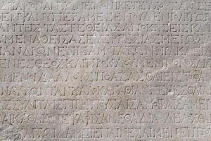 fragment of a marble slab from Chersonesos, Crimea, with a carved inscriptions in ancient Greek about the embassy in Rome photo