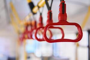 grab handles in the passenger compartment of the bus on a blurred background photo