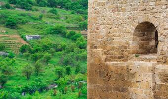 fragment of the wall of a medieval castle, behind which the faubourgs are visible, Naryn-Kala citadel in Derbent photo