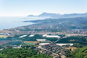 aerial view of Mediterranean coastal resort village with gardens and hotels in Camyuva, Turkey photo